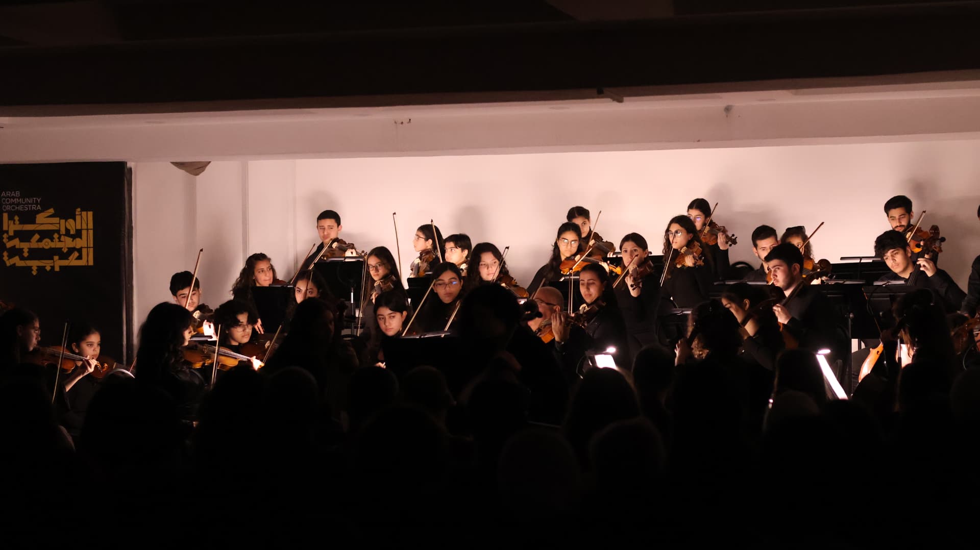Young string players performing for an audience
